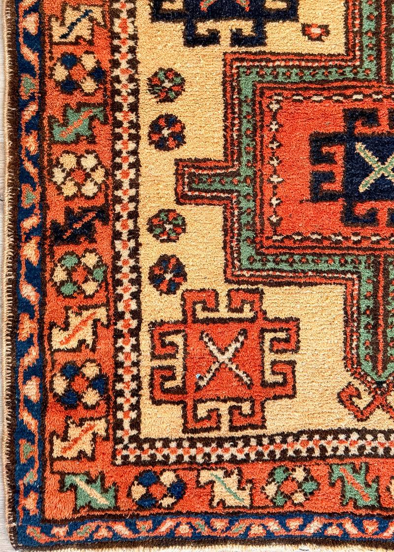Corner of Aras, a vintage Kazak-design village rug with a sand field and terracotta motifs